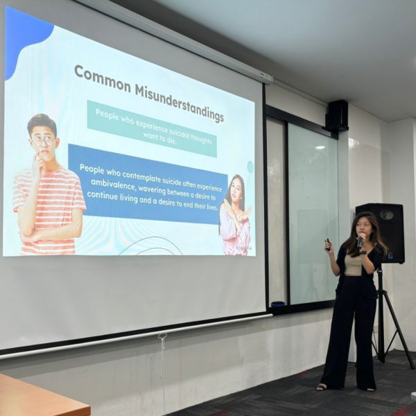 An eve & ai facilitator presenting a workplace wellbeing session to employees